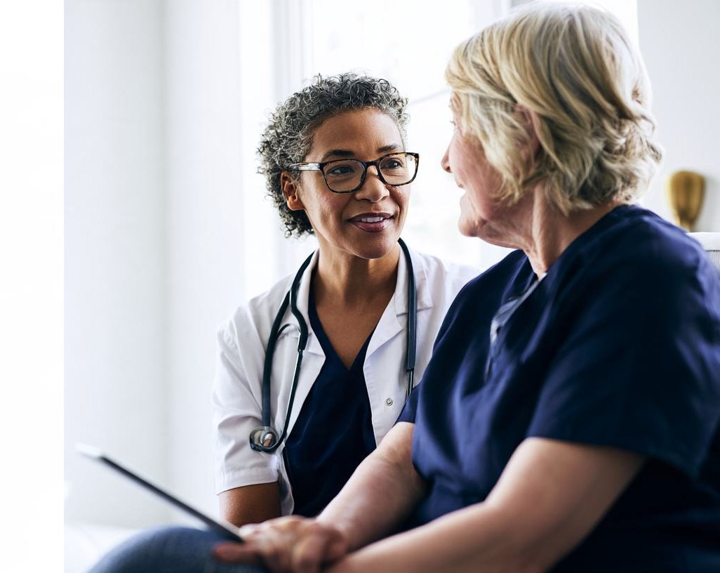 A clinician talking with a nursing home resident